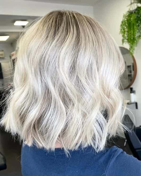 Platinum blonde hair finished with soft waves at The Establishment Hairdressing, Farnham