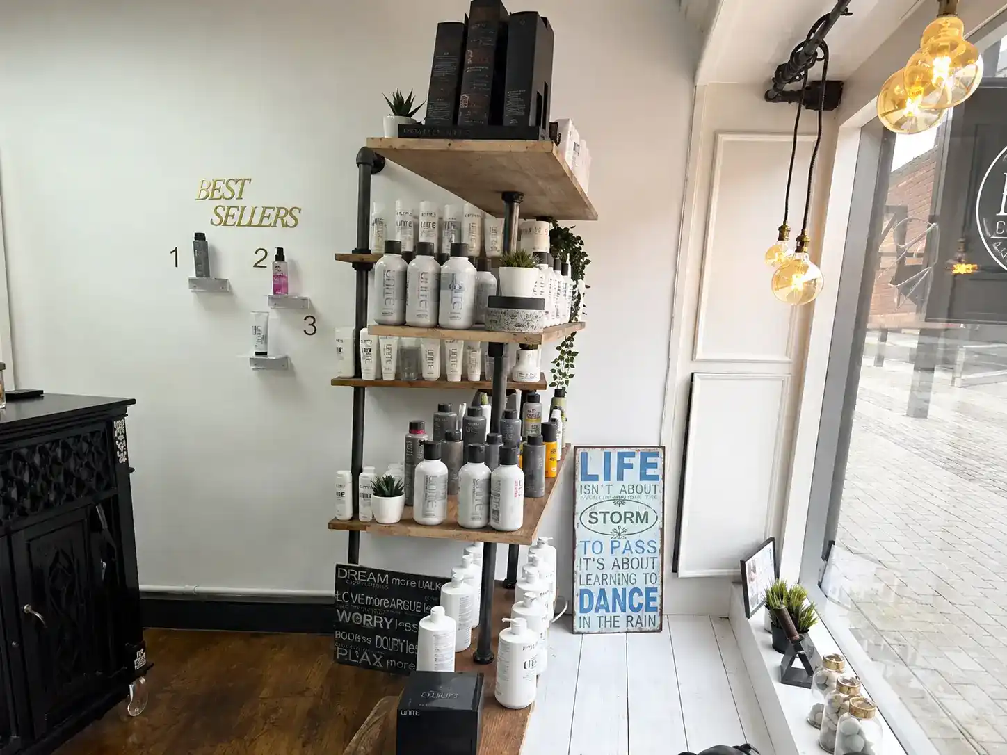 Best sellers retail shelving with amber pendant lights at The Establishment Hairdressing