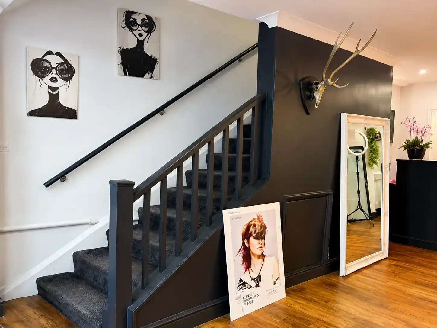 Staircase and fashion artwork at The Establishment Hairdressing